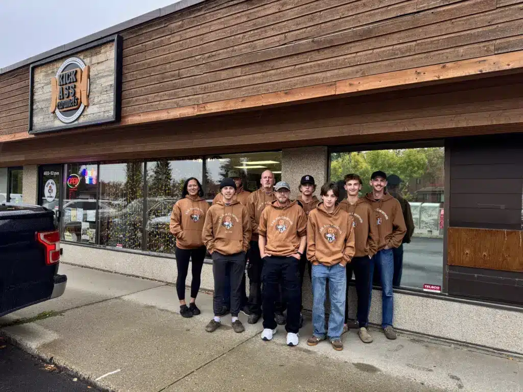 The Kick Ass Caramels crew in matching hoodies outside the shop
